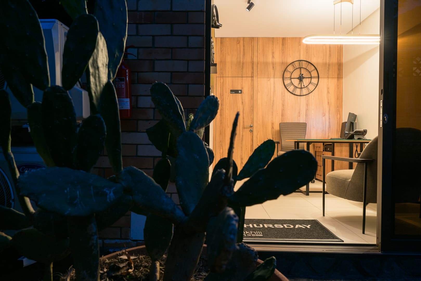 Tank Hill Inn reception through cactus garden at night